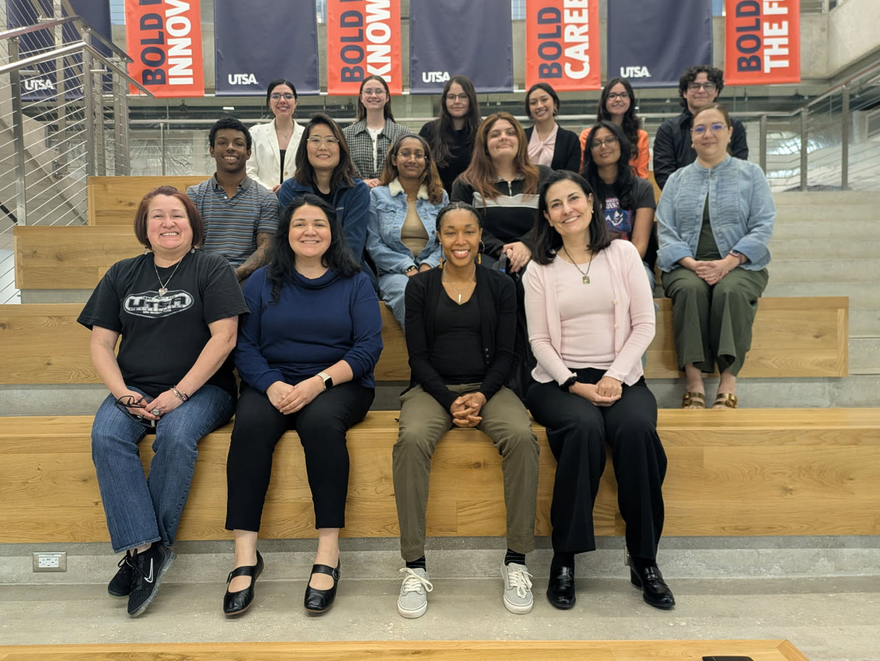 A group of women's sitting on steps for a photograph